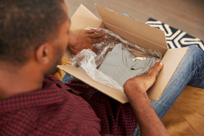 man opening clothing box