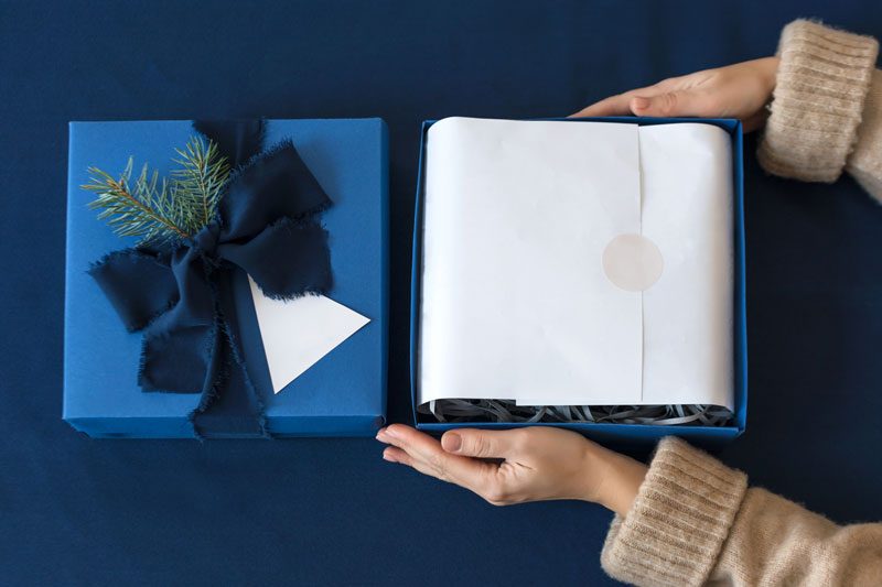 person opening a gift box